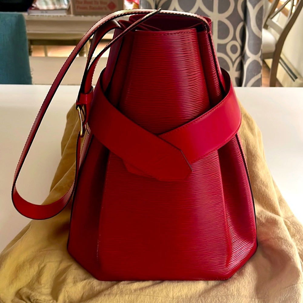 Authentic like new Louis Vuitton epi sac D’Epaule GM red castillan with wallet.